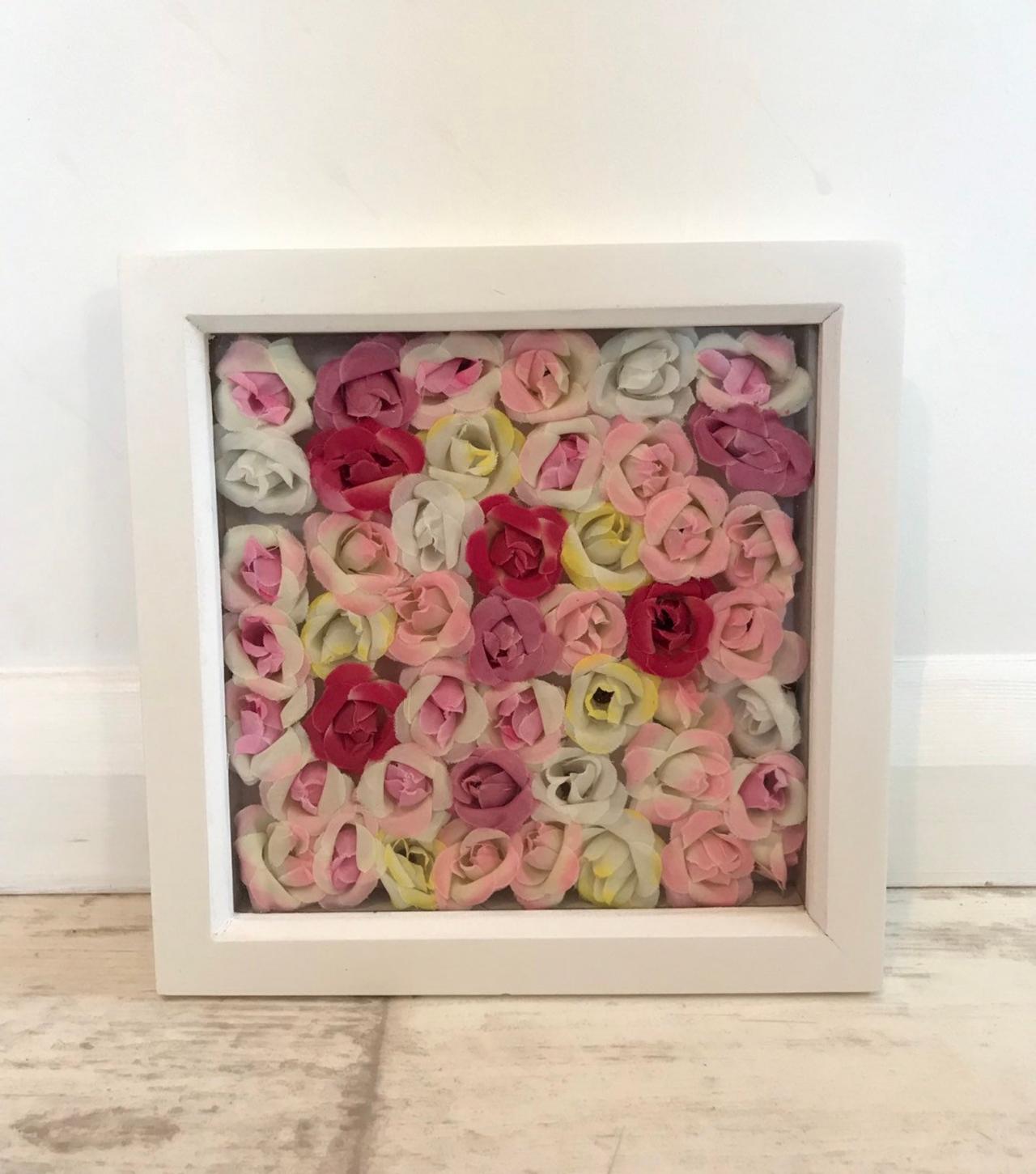 Box frame of pink and yellow flowers
